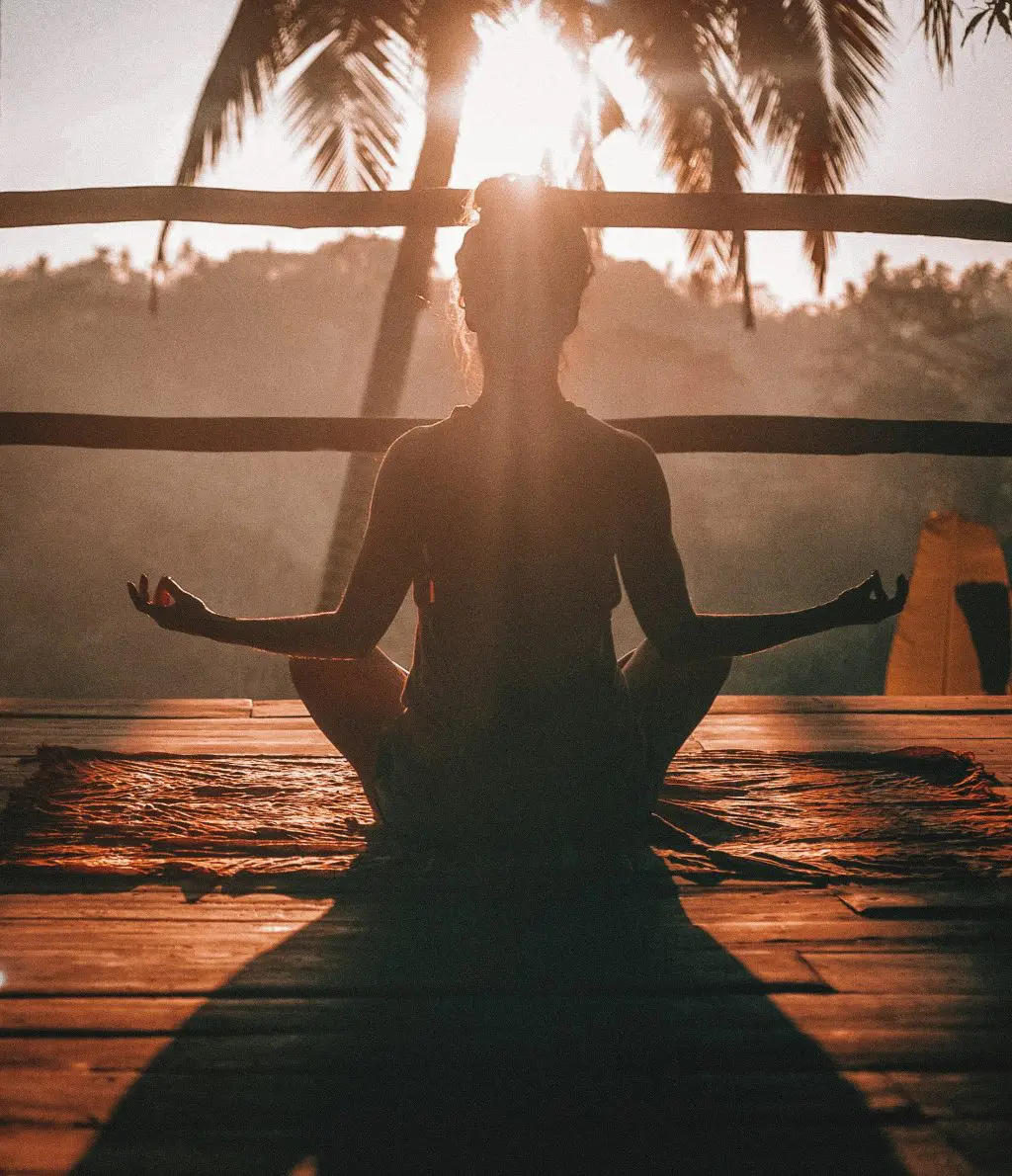 A silhouette of a woman meditating